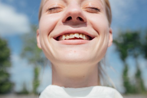 smiling woman with crooked teeth